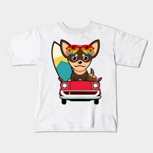 Cute small dog driving to the beach Kids T-Shirt